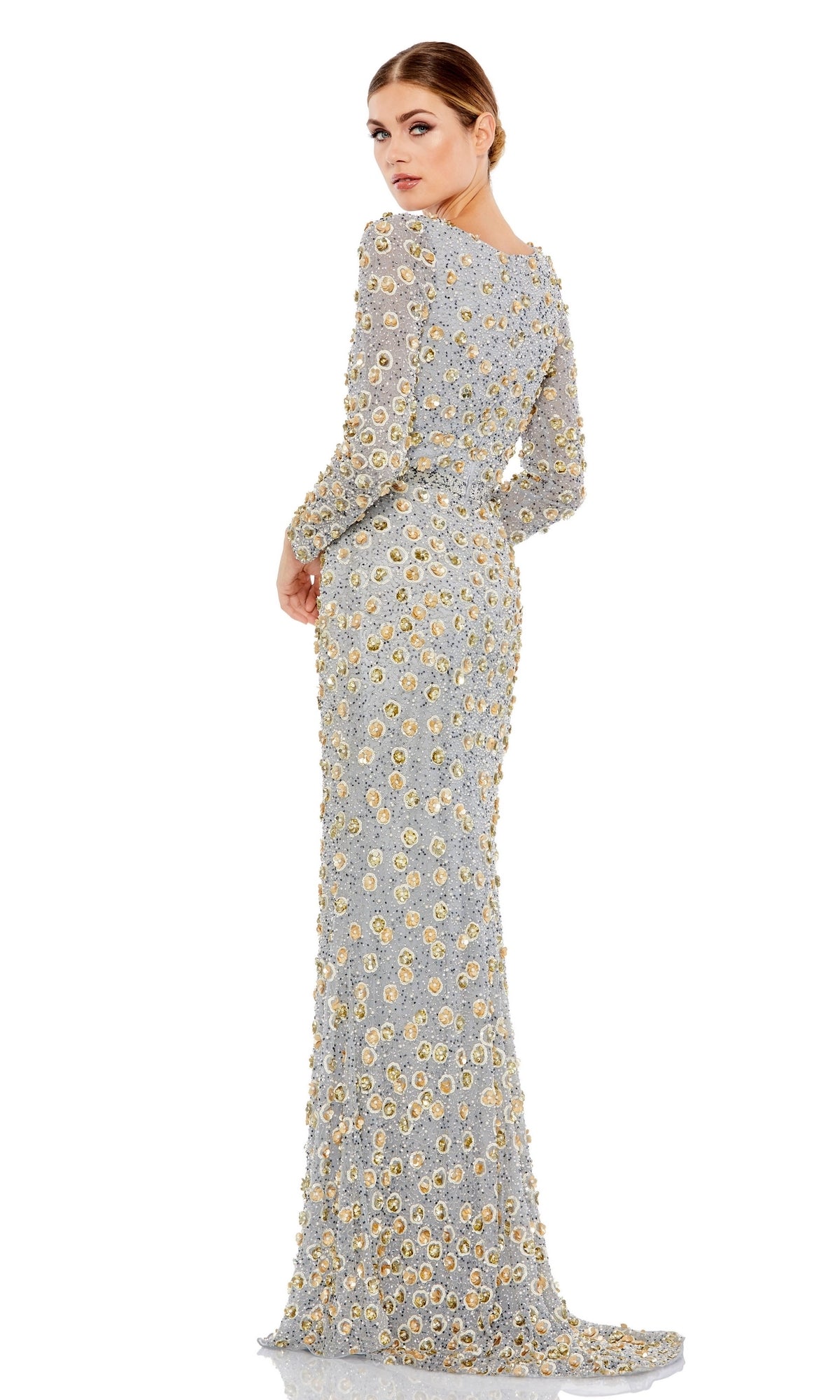 A woman models the Mac Duggal Long Formal Dress 5437, a floor-length, long-sleeved gown with gold floral embellishments, against a white background as she looks over her shoulder.